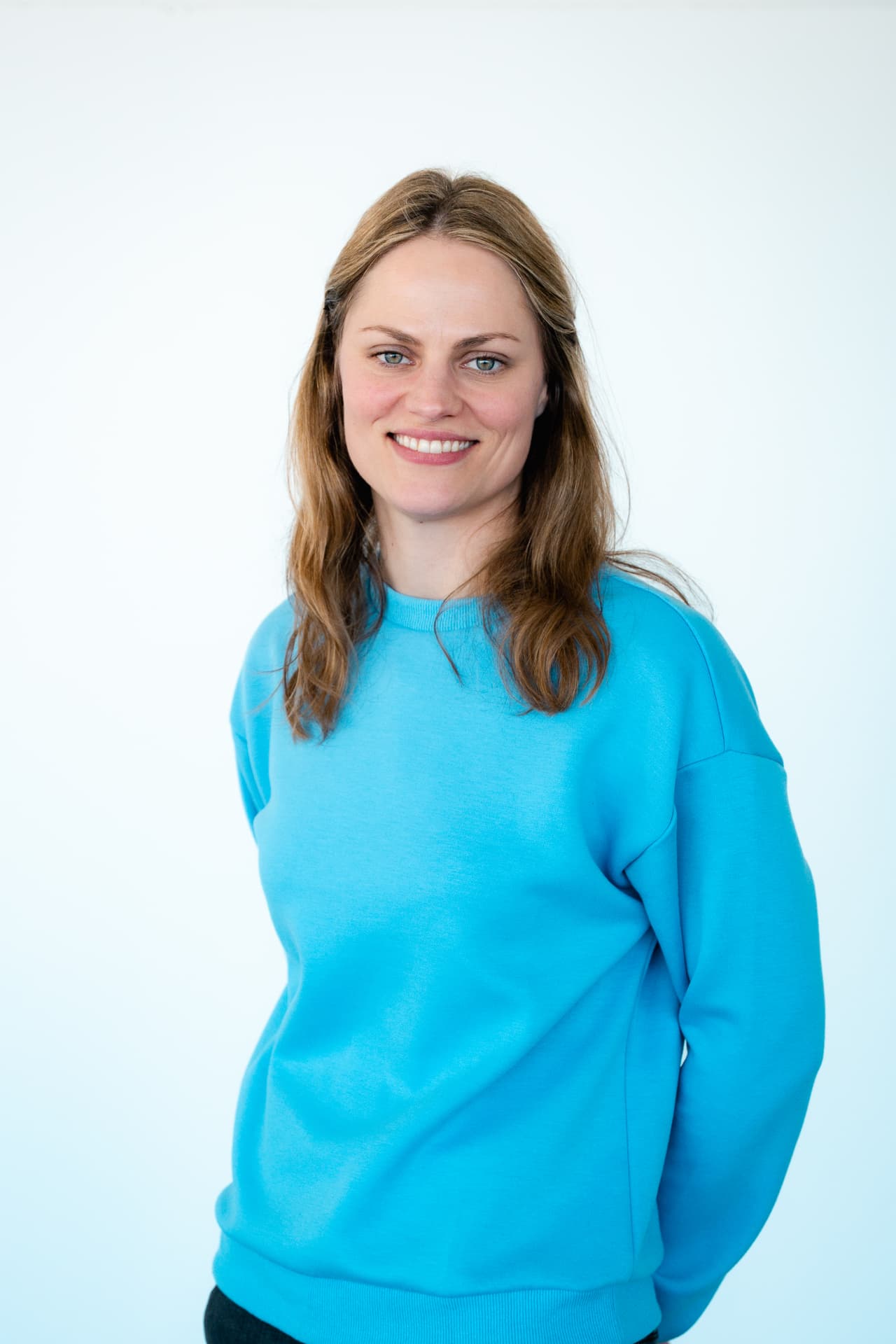 Portret van een medewerker van Attent in blauwe sweater