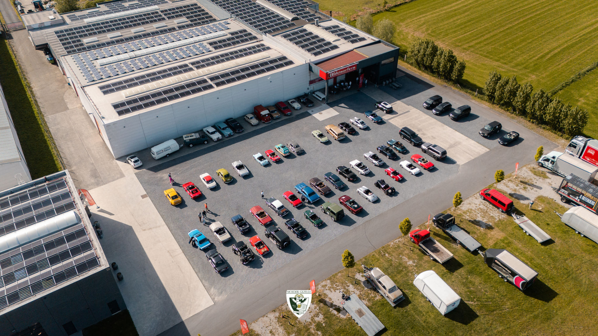 Luchtbeeld van Oldtimer Farm met tientallen klassiekers voor het gebouw